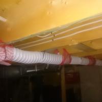 Before: Dryer vent line installed using dangerous plastic venting.